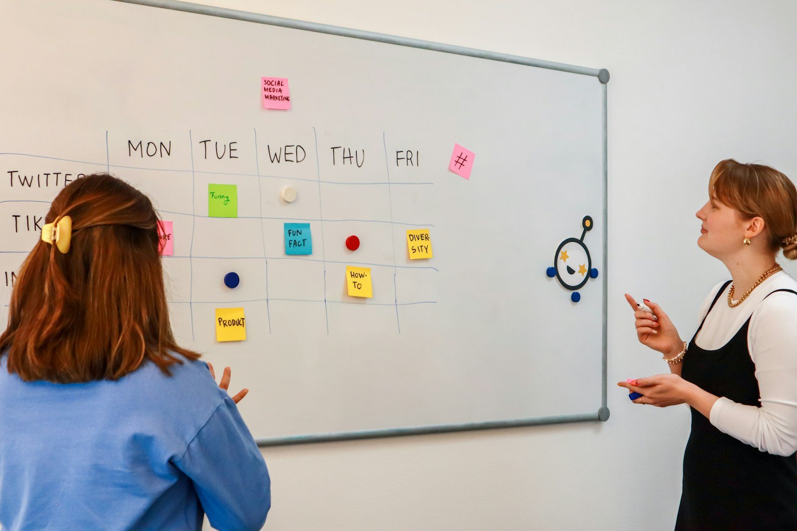 Two colleagues meeting at a whiteboard
